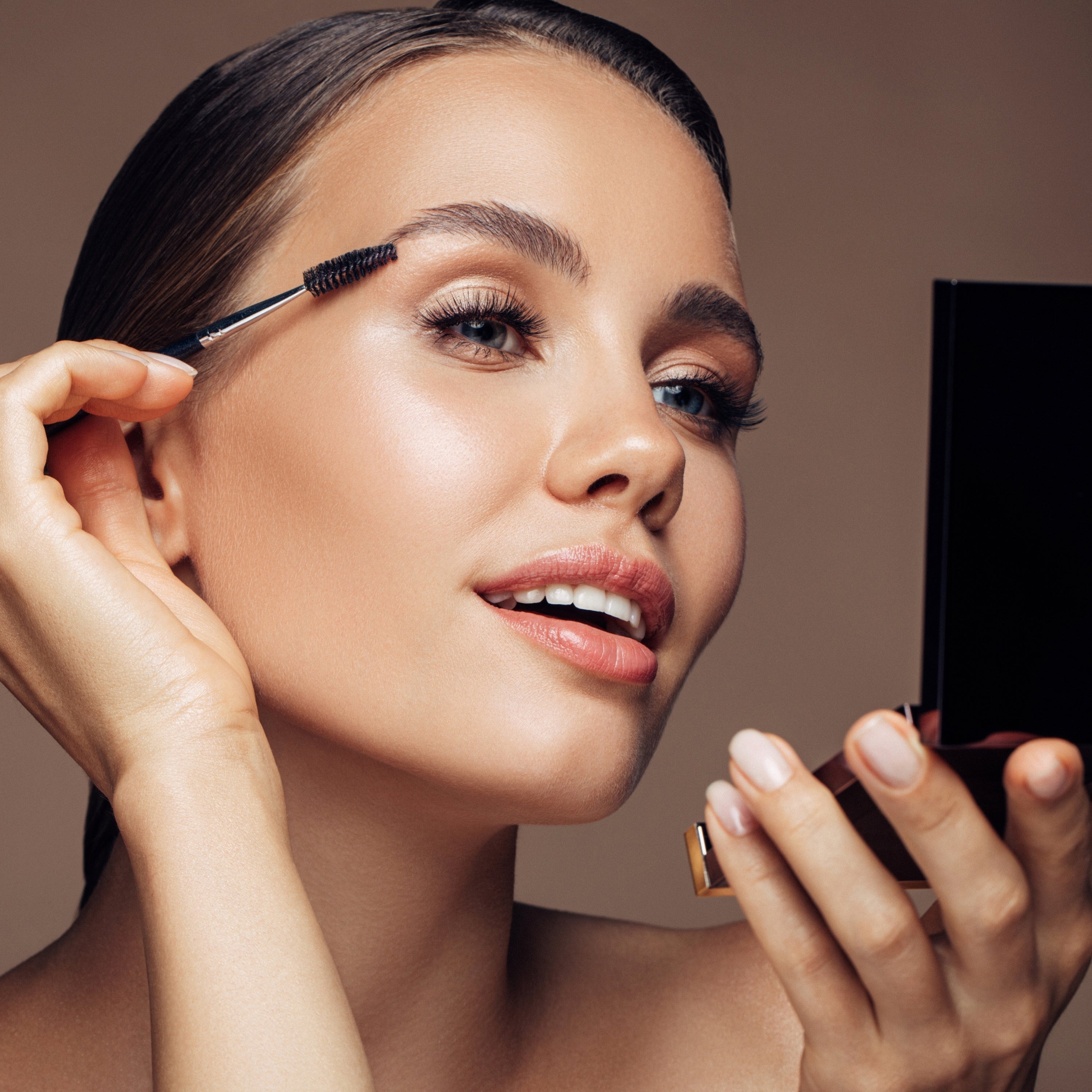 Woman applying Makeup with a soft glam look and natural lighting.