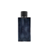 Abercrombie & Fitch First Instinct Blue bottle close-up highlights a fresh, long-lasting aroma.