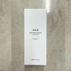 Abib Heartleaf Essence application on cheek emphasizes soothing hydration.