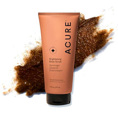 Acure Brightening Body Scrub jar close-up showing exfoliating texture for radiant skin.