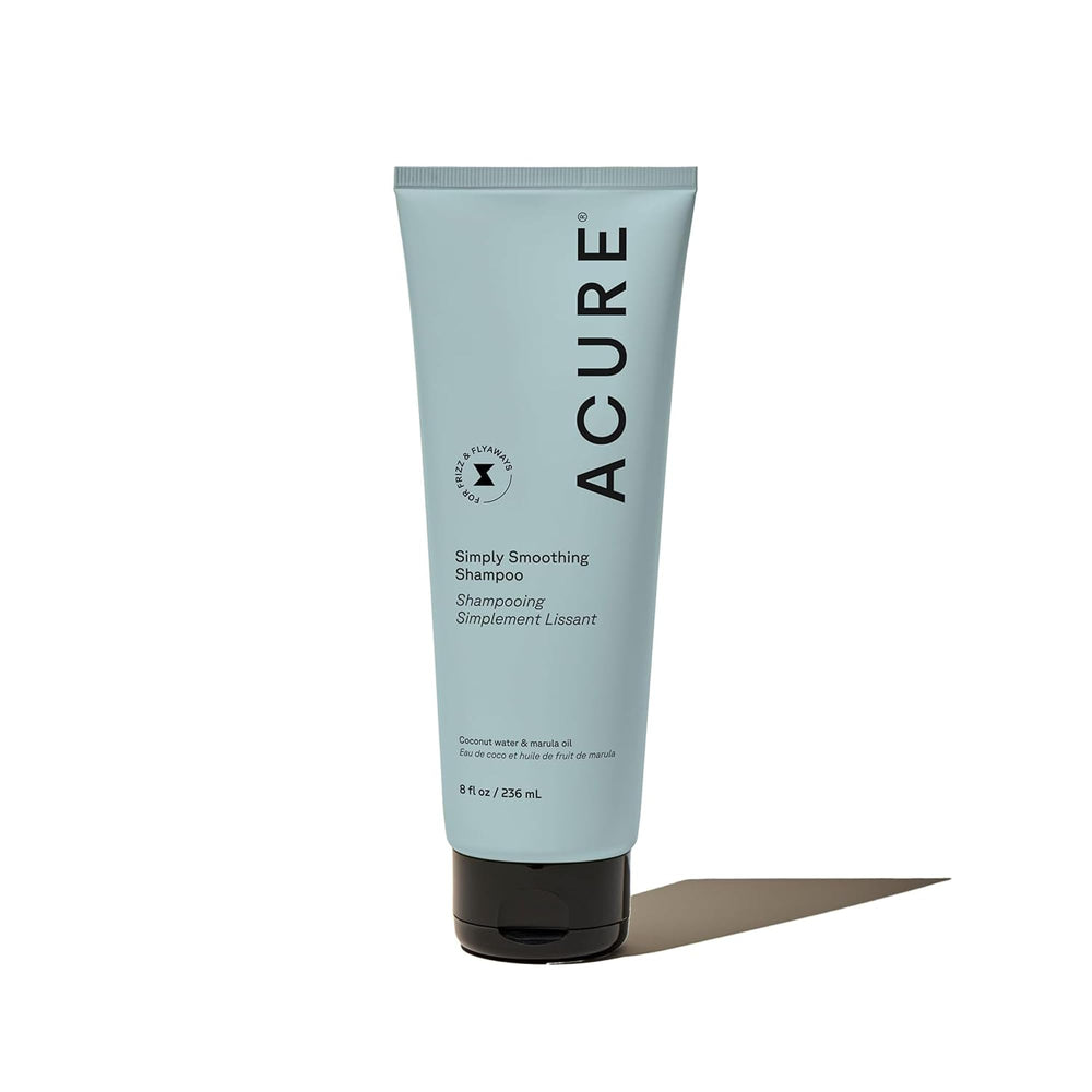 Acure Simply Smoothing Shampoo bottle closeup with frizz control for smooth hair.