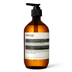 Aesop Resurrection Aromatique Hand Wash bottle on a sink offering gentle cleansing.