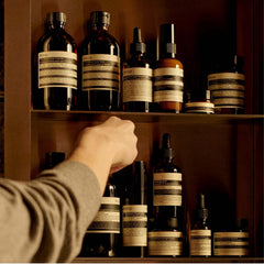 Aesop Rind Concentrate Body Balm with pink grapefruit ingredient close-up for citrus nourishment.
