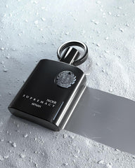 Afnan Supremacy Noir luxury bottle on a dress shirt suggests versatile day-to-night styling.