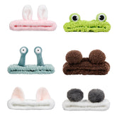 AIBFRID green frog headband keeps hair away for a clean skincare routine.