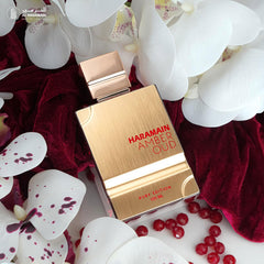 Al Haramain Amber Oud Ruby Edition bottle angled shot emphasizes warm amber tones.