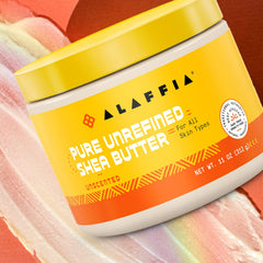 Alaffia Shea Butter Unscented 11 oz in hand demonstrates hair moisture and shine application