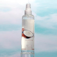 ALURAM Coconut Water Texture Spray on damp hair for hydrated, defined waves.