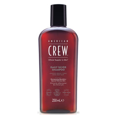 American Crew Daily Silver shampoo bottle being poured to reduce brassy yellow tones for gray hair.