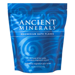 Ancient Minerals Magnesium Bath Flakes bottle close-up for relaxation and wellness soak.