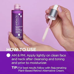 Andalou Naturals plant-based retinol serum being applied with clean fingertips.