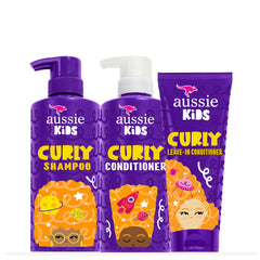 Aussie Kids curly shampoo bottle being poured for gentle cleansing.