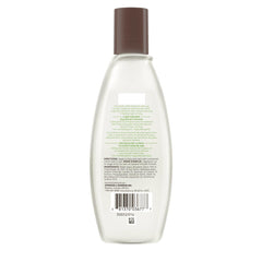 Aveeno toner being applied to clean skin for oil-free toning.
