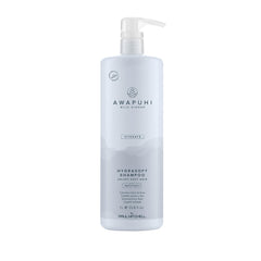 Awapuhi Wild Ginger HydraSoft Shampoo bottle on bathroom shelf delivering moisture and shine daily care.