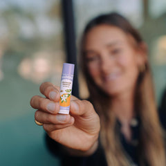 Badger Lavender Orange Lip Balm on lips shows a light shine and soothing feel