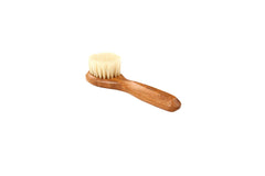 Bass facial cleansing brush with wood-handle natural bristles for gentle cleansing.