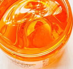 Bella & Bear Fizzy Clementine Shower Jelly amber bottle on shelf signals refreshing morning routine.