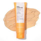 BellamiLuxx Body Acne Scrub bottle close-up shows exfoliating formula for smoother skin.