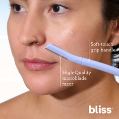 Bliss dermaplaning tool gliding along clean, damp skin during routine.