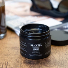 Brickell Men's pomade glossy finish enhances sleek hairstyles with a polished look.
