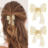 CAKURE pearl bow hair clip gold close-up showing secure grip.