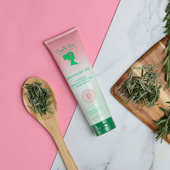 Camille Rose ingredient montage highlights rosemary, peppermint, and biotin for nourishing care