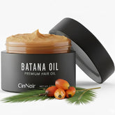 CinNoir Batana Oil bottle on a dresser promotes hair nourishment and natural shine.