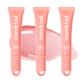 Cocokind Ceramide Lip Blur Balm pack swatch shows coral pink tint and hydration