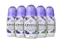 Crystal Essence CRYSTAL deodorant roll-on bottle shows mineral barrier for odor control.