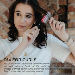 Denman D14 in hands styling bangs for smoother fringe.