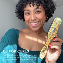 Denman D3 7-Row Brush on hair with anti-static pad for improved grip and control.