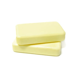 DermaHarmony bar in hand creating a rich lather for cleansing.