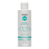 DHS Clear Shampoo bottle closeup showing unscented formula for sensitive skin.