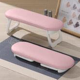 Diesisa nail arm rest folded for compact storage on a busy salon table.