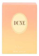 Dior Dune on a beach backdrop evoking vacation mood and escape.