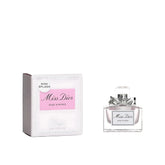 Miss Dior Rose N' Roses bottle with a silver ribbon, elegant gifting.