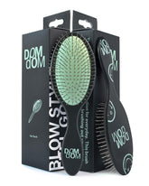 Dom Dom detangling brush in shower with drainage hole for fast drying.
