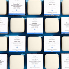 Drunk Elephant Pekee Bar application on face and neck delivers gentle cleansing.
