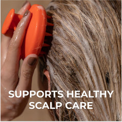 DS Laboratories Revitalizing Scalp Brush during massage promotes even shampoo distribution.
