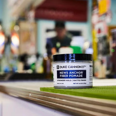 Duke Cannon News Anchor Fiber Pomade hands applying for easy restyling.