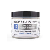 Duke Cannon News Anchor Fiber Pomade tube closeup for strong hold results.