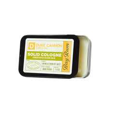 Duke Cannon Bay Rum solid cologne compact tin, travel-ready scent companion.