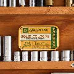 Duke Cannon Bourbon solid cologne tin open reveals balm texture.