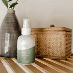 Earth Mama Belly Oil belly massage application, nourishing skin during pregnancy.