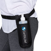 EarthLite massage bottle holster on waistband for quick tableside access.