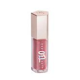 Fenty Beauty Gloss Bomb Lip Oil bottle glowing with rosy shimmer and hydration.