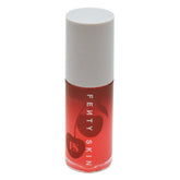 Fenty Skin Treatz lip oil bottle being applied for quick hydration and lip conditioning.