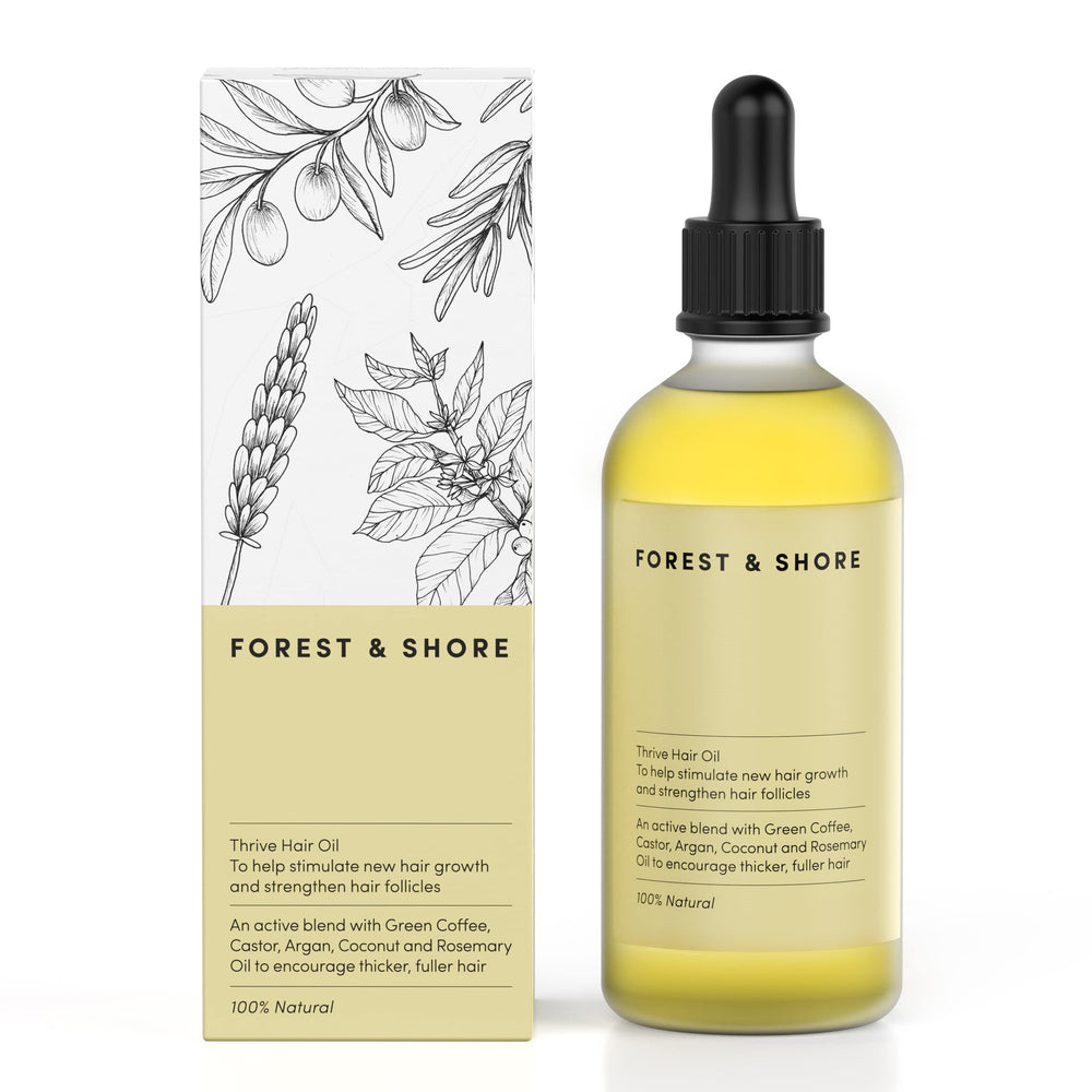 Forest & Shore Hair Growth Oil bottle closeup on wood showing natural nourishment