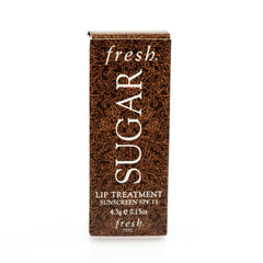 Fresh Sugar Lip Treatment SPF 15 full-size tube close-up highlights nourishing lips and sheer color.