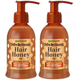 Garnier Whole Blends Honey Treasures serum bottle demonstrates non-greasy repair for damaged hair